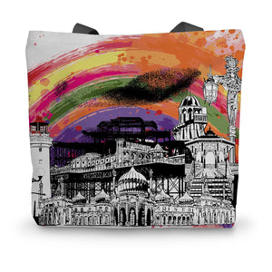 White shopping tote with a black and white illustration of Brighton pier and its various landmarks and features. The design also features a rainbow splash across the background.
