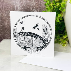 Greeting card with black and white illustration of a bridge and buildings on a white background