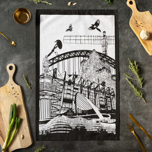 Powder Butterfly teatowl featuring famous newcastle landmarks and icons in black/white