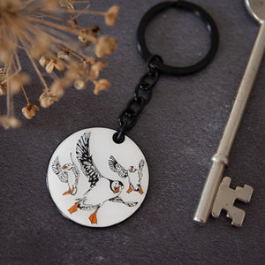 black and white illustrated enamel keyring by powder butterfly featuring the famous puffin