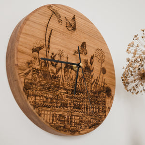 Angled view of the saltwell park woodburned clock by powder butterfly featuring saltwell parks famous icons and landmarks