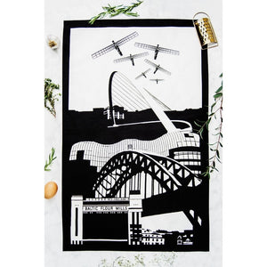 PowderButterfly 100% Organic Cotton Newcastle Tea Towel with black and white illustration of Newcastle and Gateshead monuments and landmarks