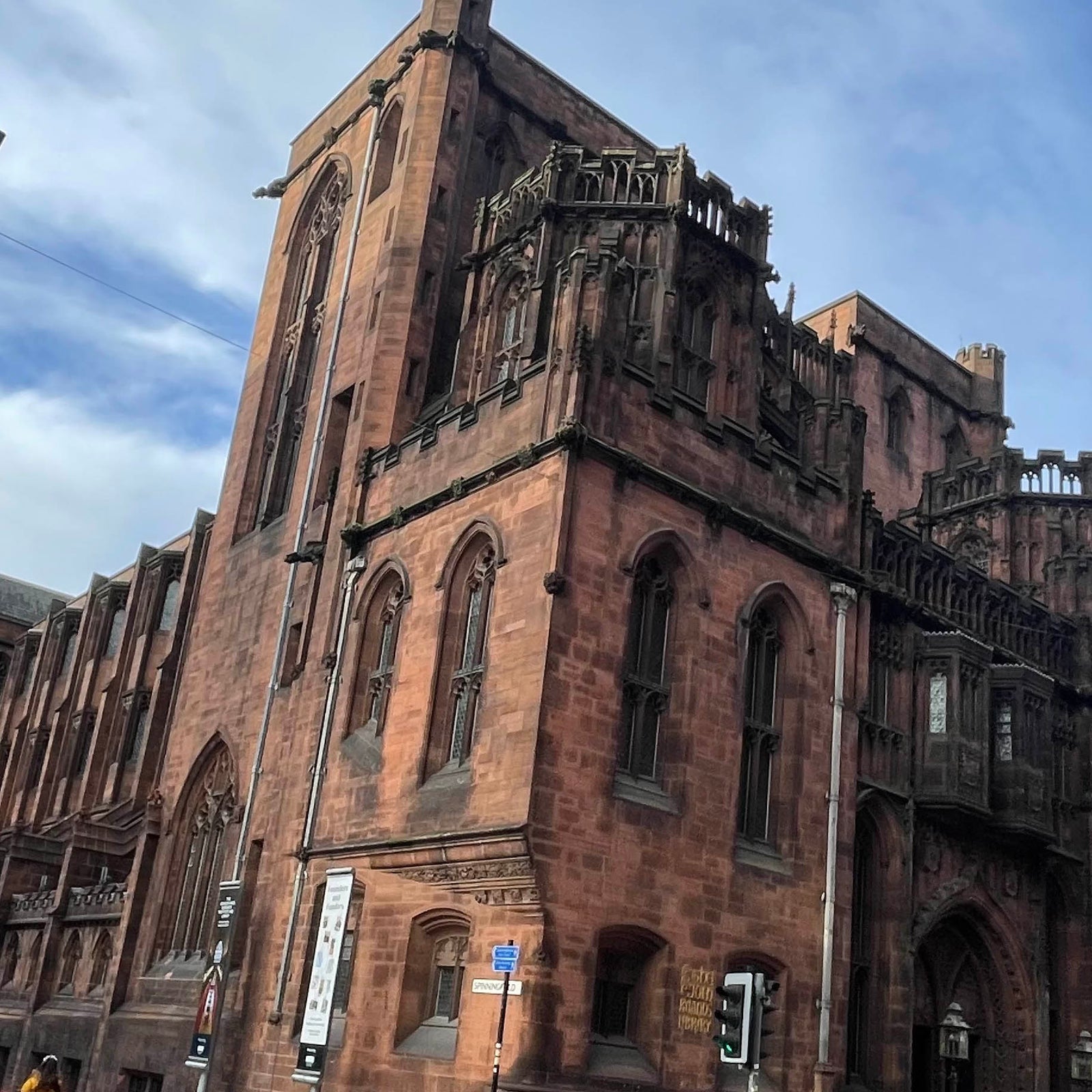 image of John Rylands Library in Manchester, red brick building against a blue sky | Powder Butterfly | Manchester Gifts