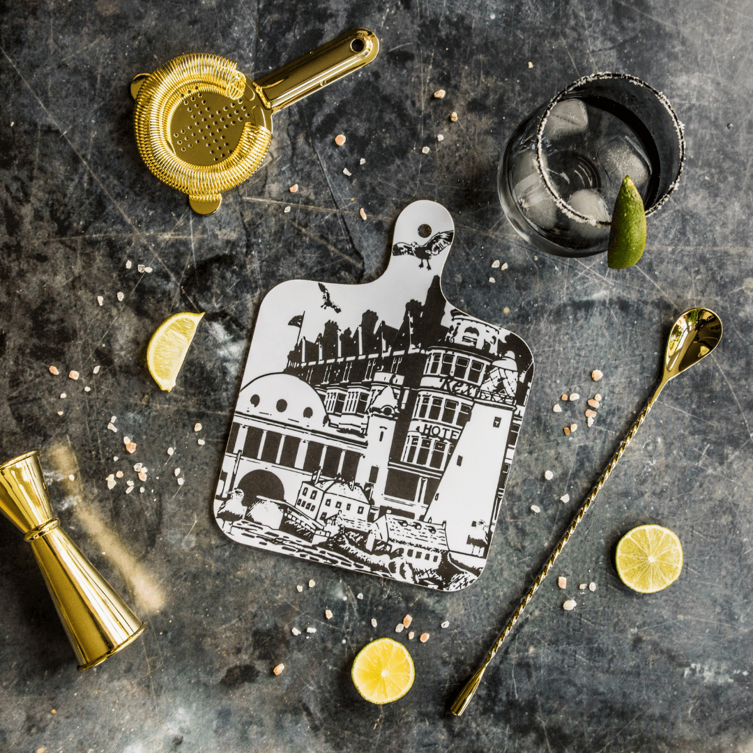 black and white illustrated chopping board  featuring landmarks and monuments from whitley bay