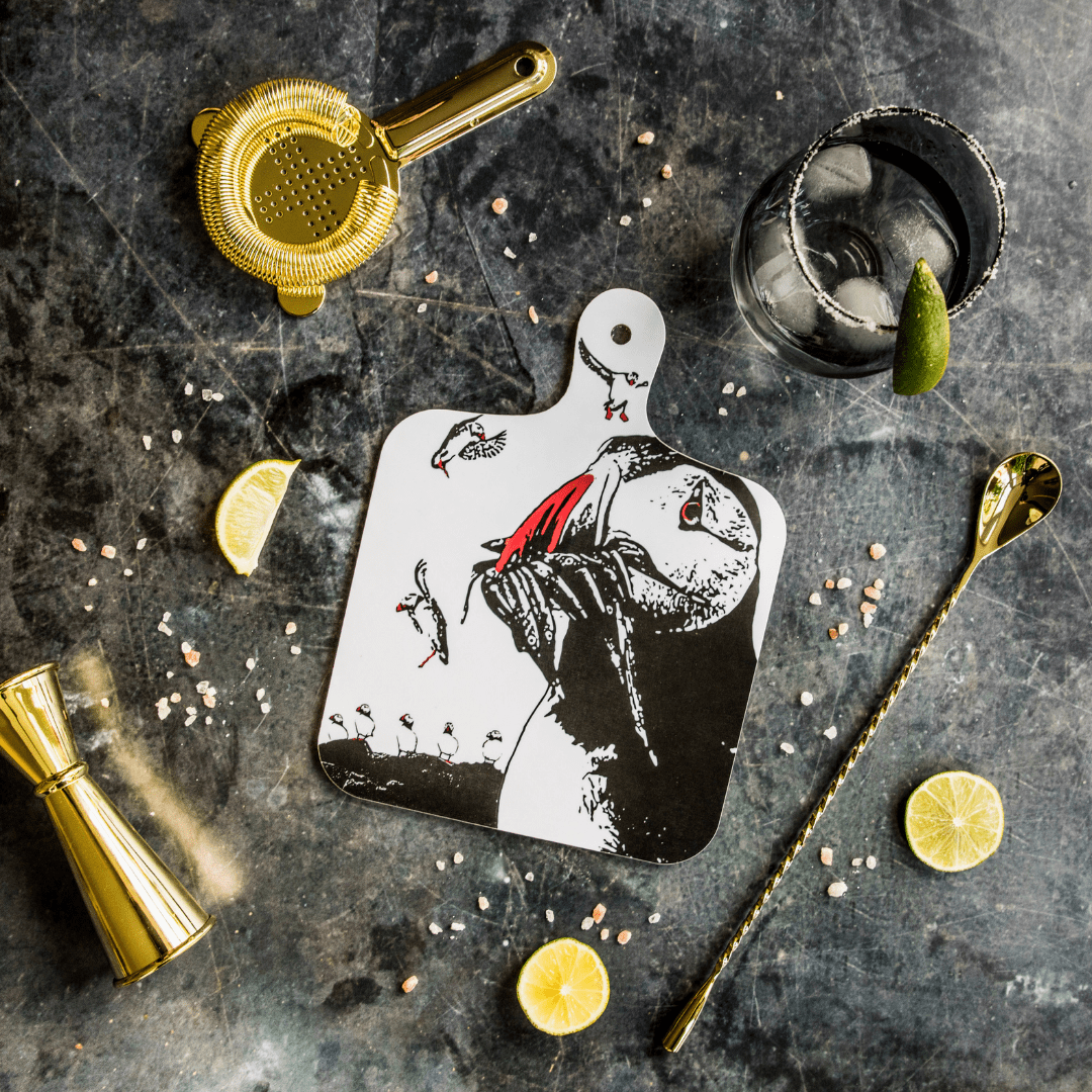 Farne Island Puffin Chopping Board - Powder Butterfly featuring a black adn white illustrated design of some puffins detailed with orange