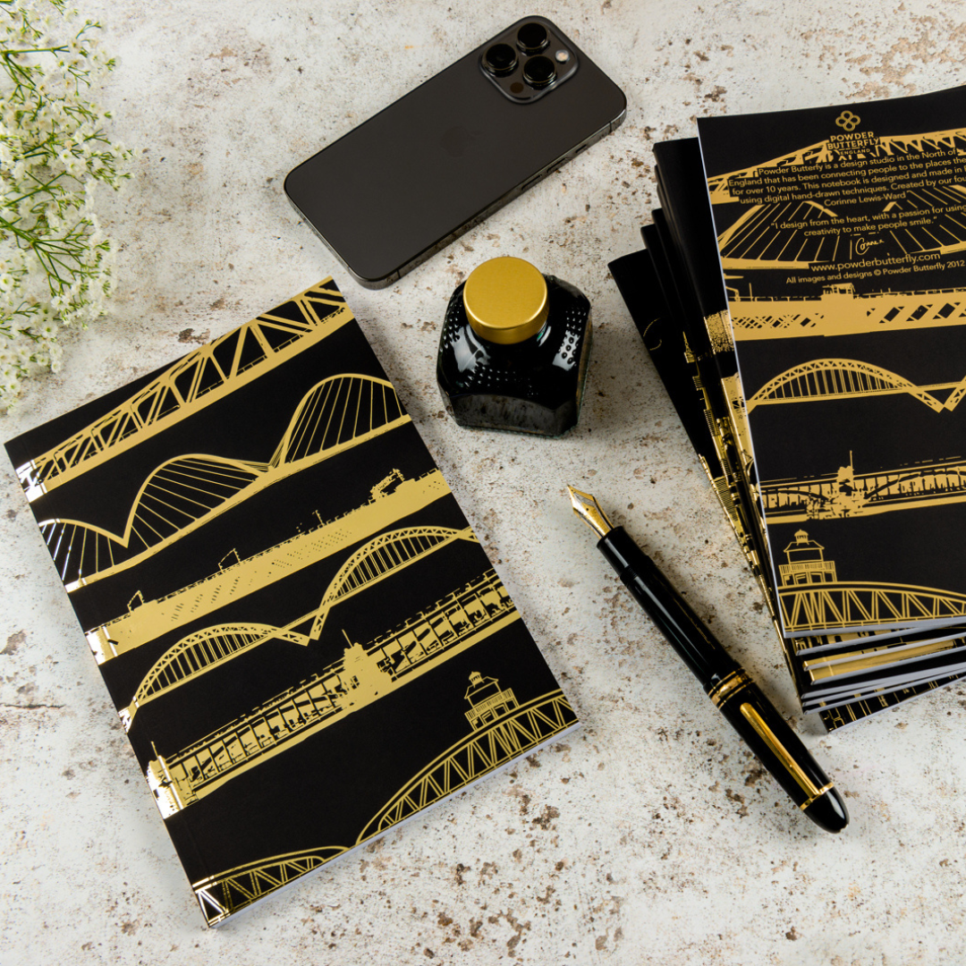 Black notebook with gold foil illustrated with famous bridges from around the UK