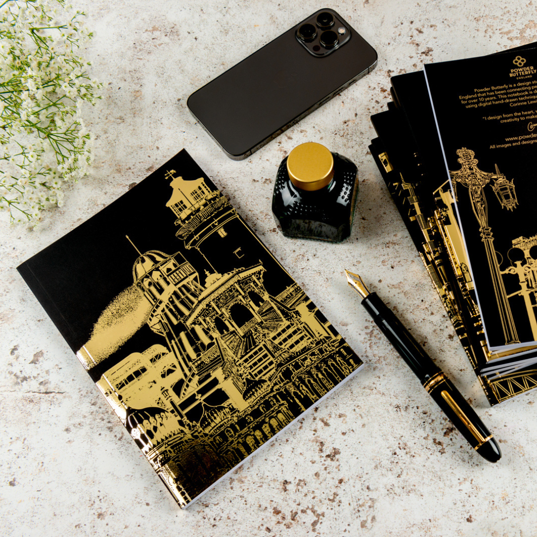 Black notebook featuring gold foil and illustrated with famous landmarks from Brighton in the UK.