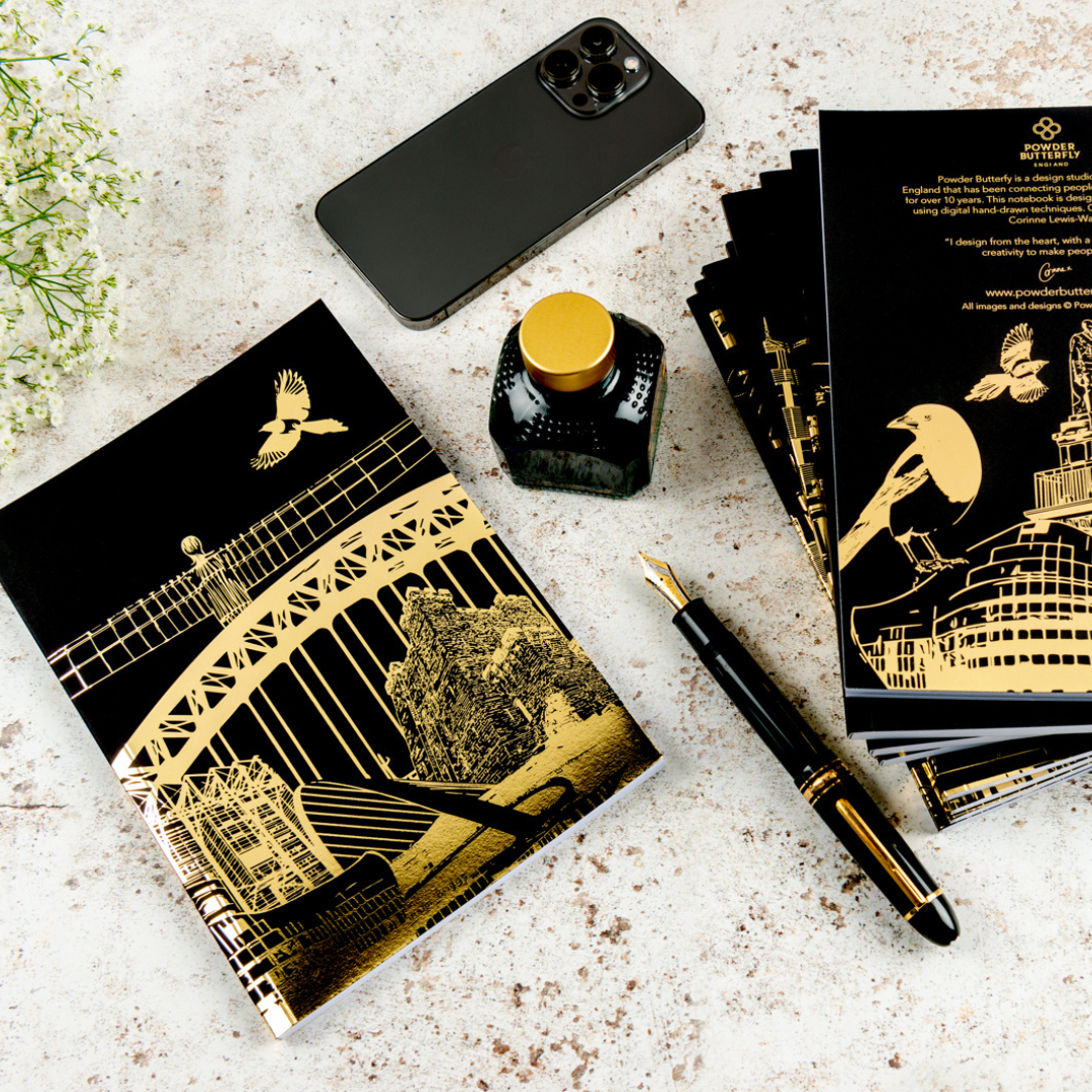 a black notebook with gold foil illustrations featuring famous Newcastle Landmarks and symbols