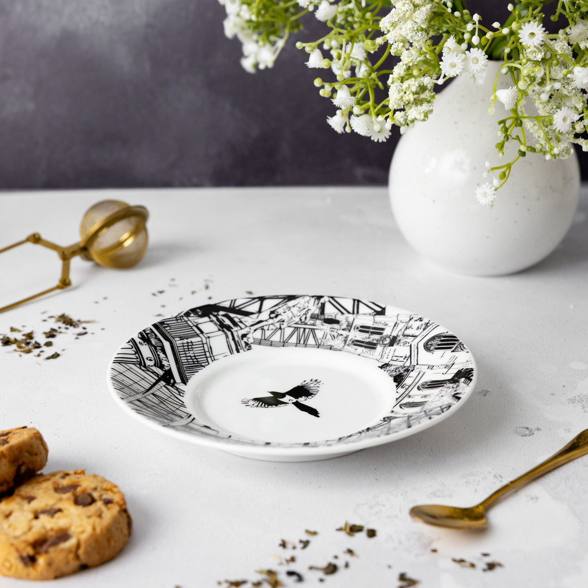 side profile image of the saucer without cup, saucer features famous Newcastle landmarks and the ionic magpie.