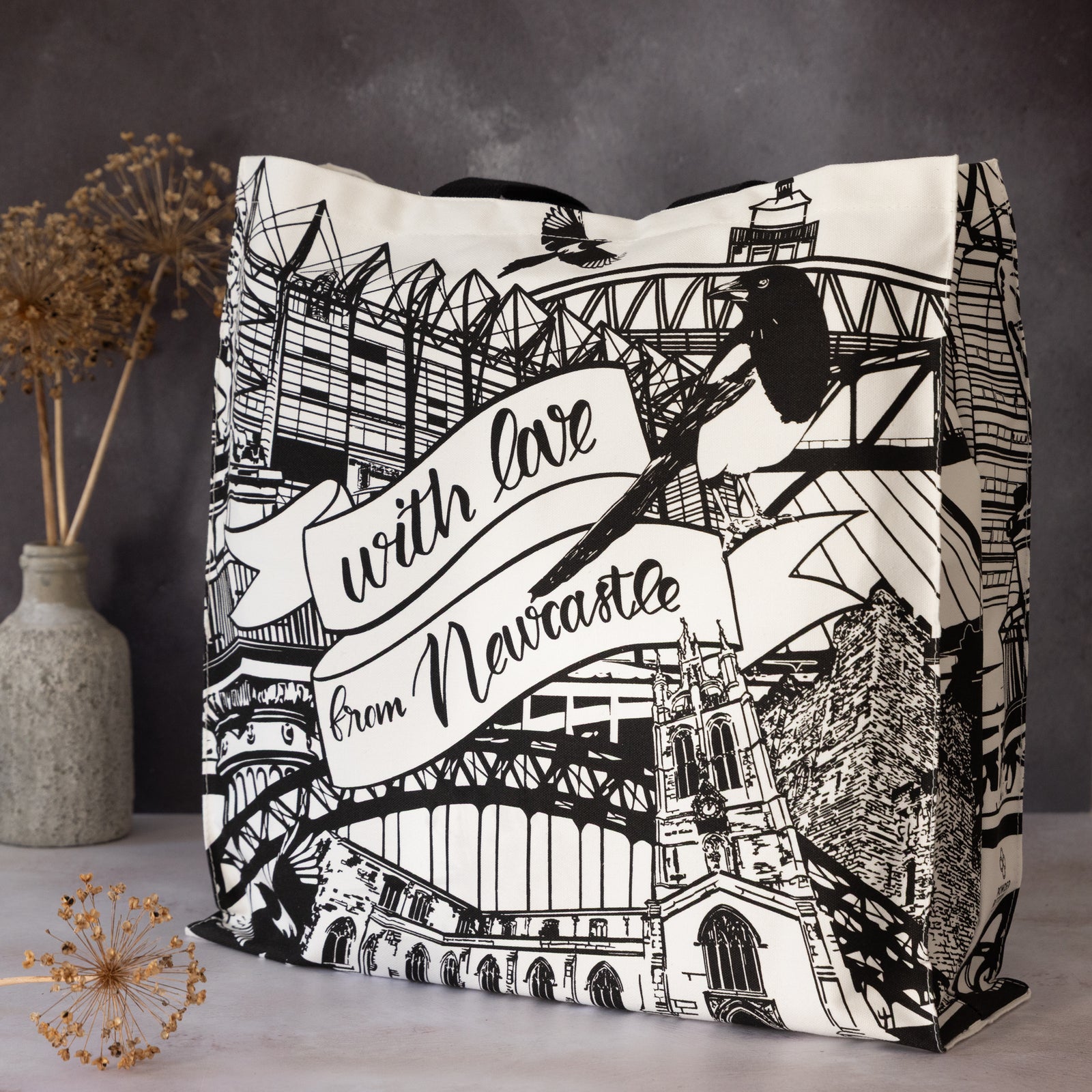 Decorative view of the newcastle alndmarks themed tote bag by powder butterfly featuring famous icons and landmarks from newcastle and illustrated in black and white