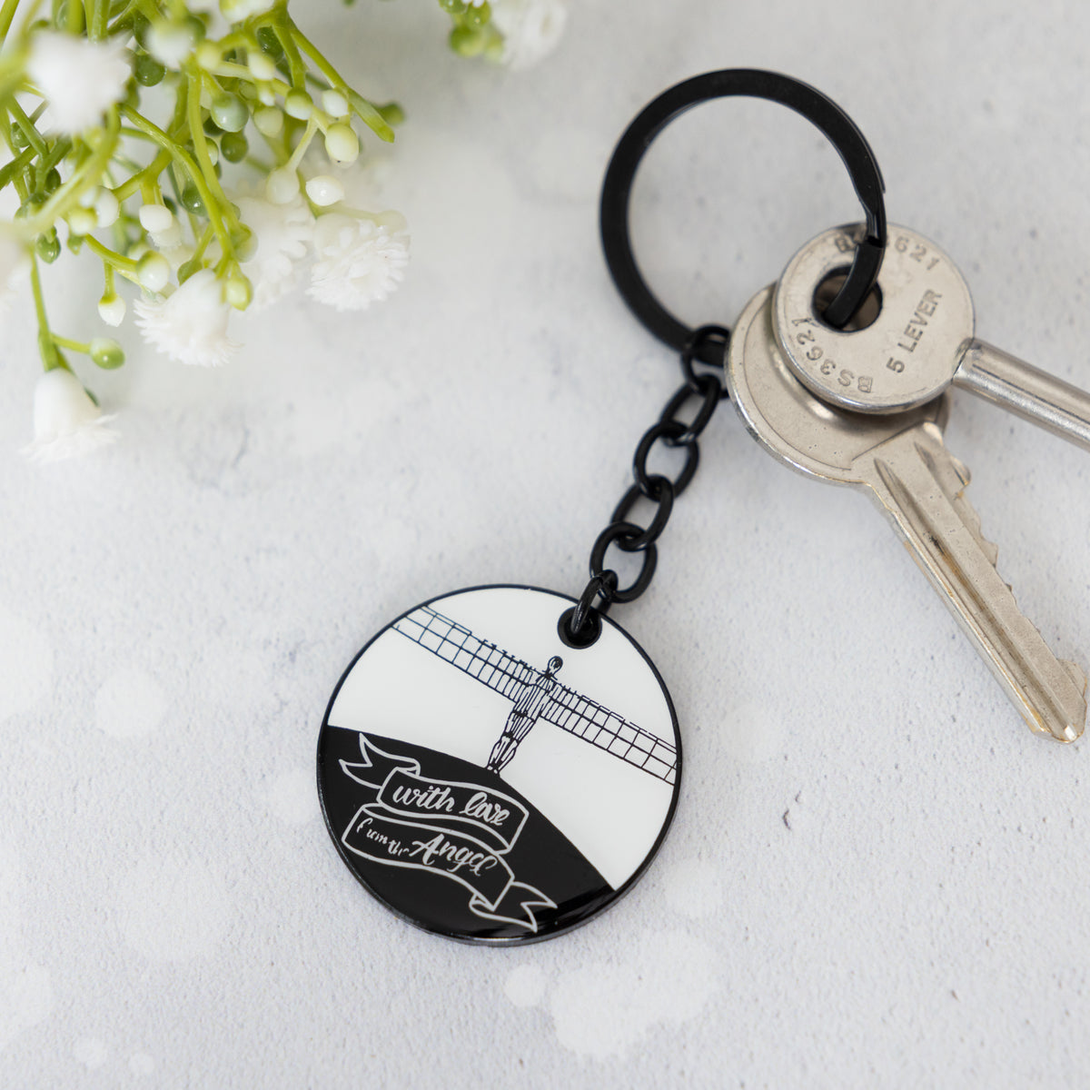 white and black illustrated enamel keyring of the angel of the north by powder butterfly