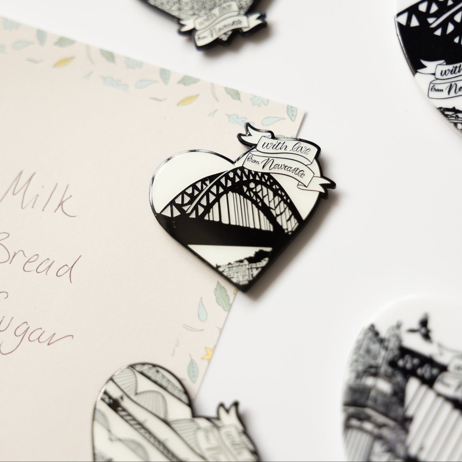 the tyne bridge fridge magnet set by powder butterfly. Enamel badges with black and white illustration