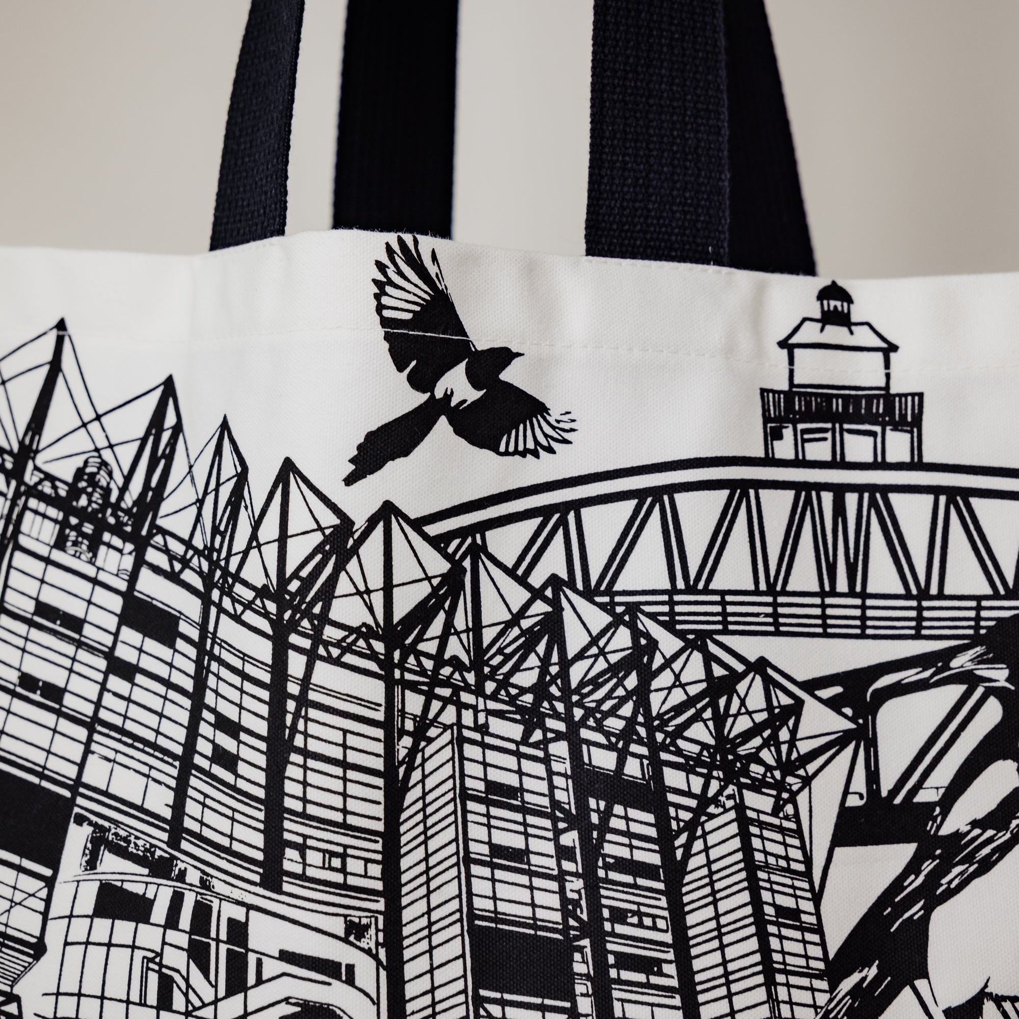 Decorative view of the newcastle alndmarks themed tote bag by powder butterfly featuring famous icons and landmarks from newcastle and illustrated in black and white