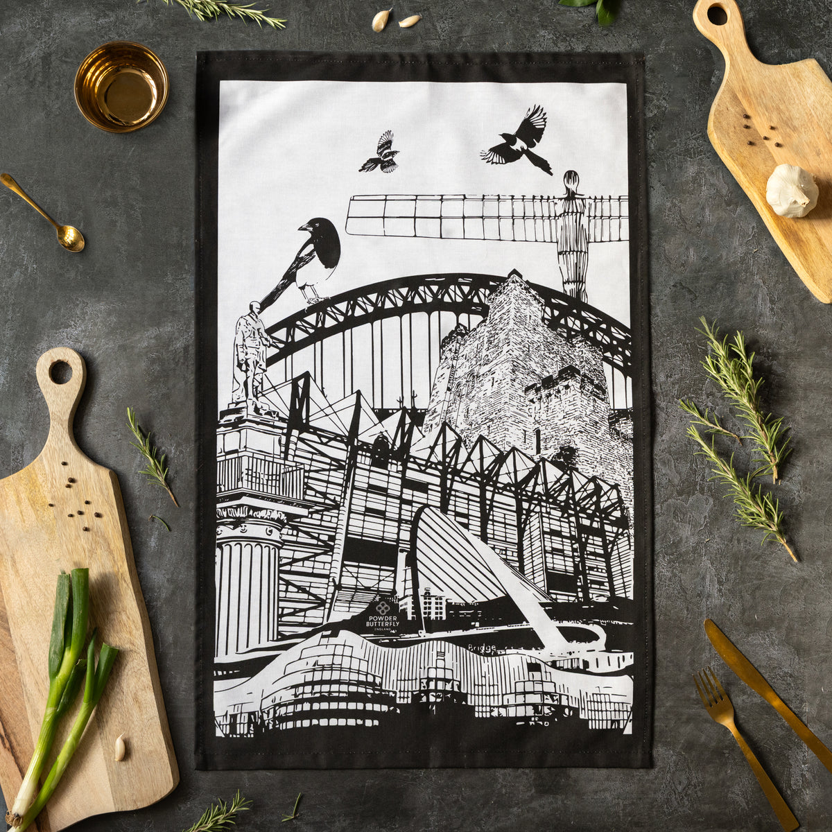 Powder Butterfly teatowl featuring famous newcastle landmarks and icons in black/white