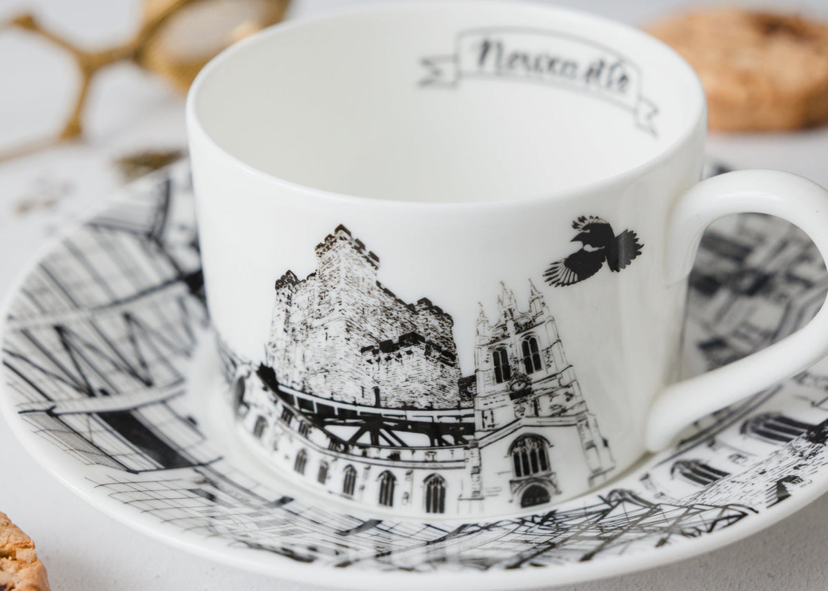 Ceramic cup and saucer with Newcastle landmarks design on a light background