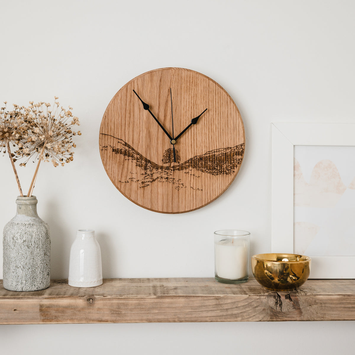 Sycamore gap woodburned clock by powder butterfly front view over a shelf