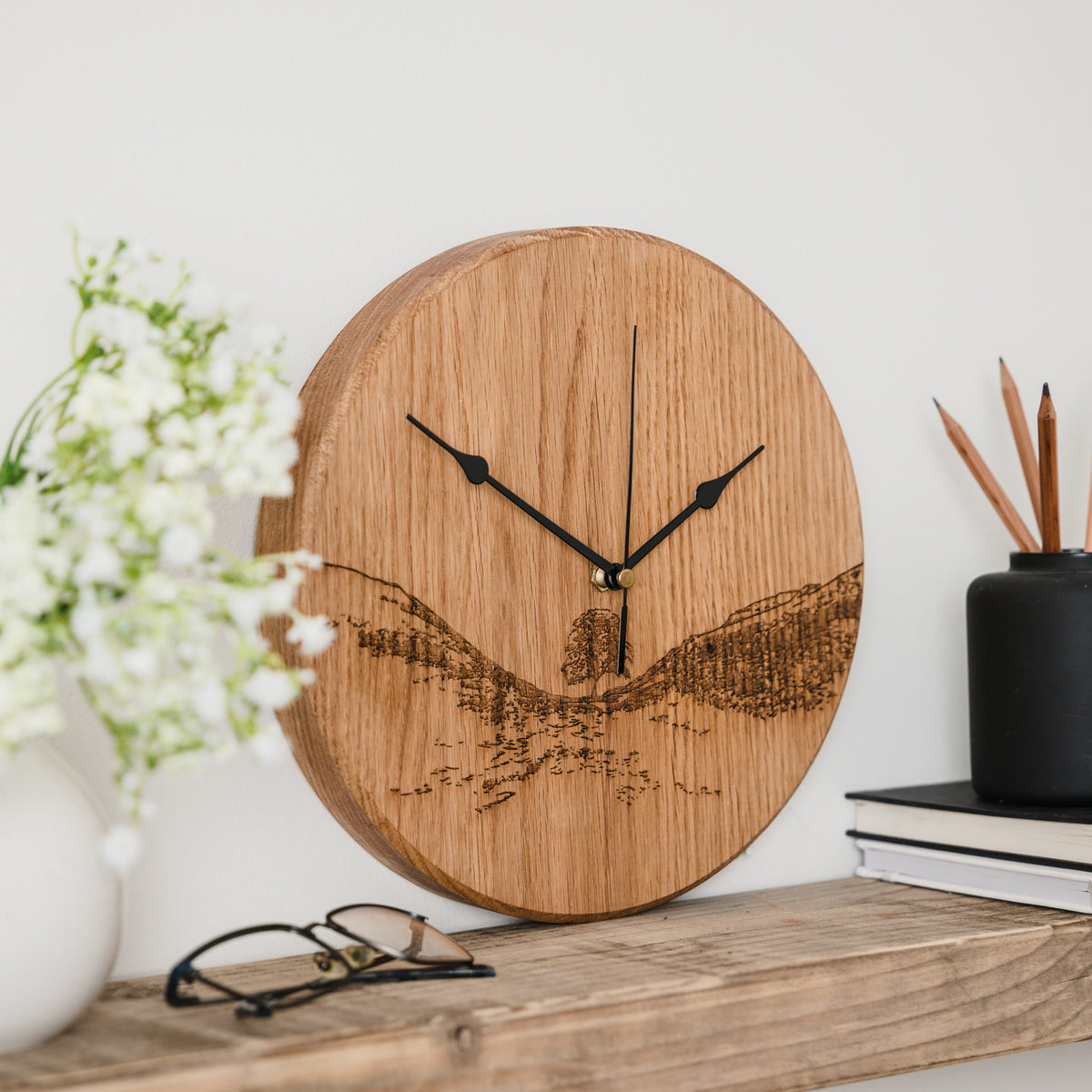 Woodburned sycamore gap clock by powder butterfly sat on shelf