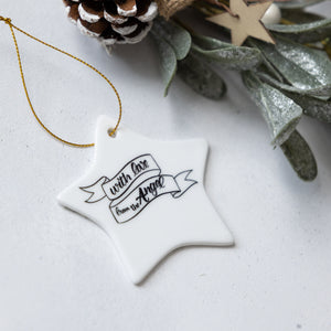 Star-shaped ornament with text on a white surface with decorative elements.