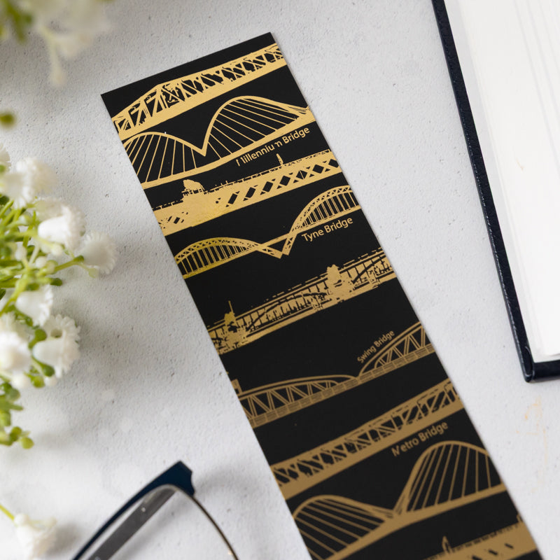 Detail of Tyne Bridges bookmark laid on a white table.