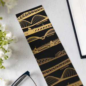 Detail of Tyne Bridges bookmark laid on a white table.