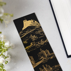 Details of Black soft touch bookmark with gold foil castle design on a white background.