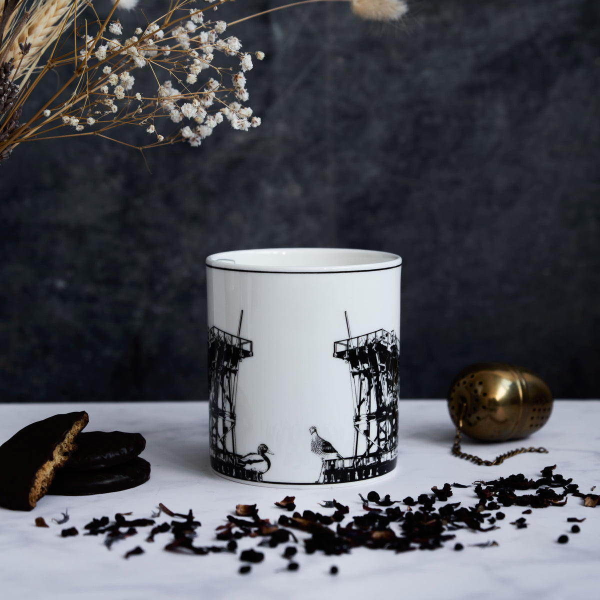 Front facing side of the Dunston Staiths mug featuring various hand draws wildlife and the staiths themselves.
