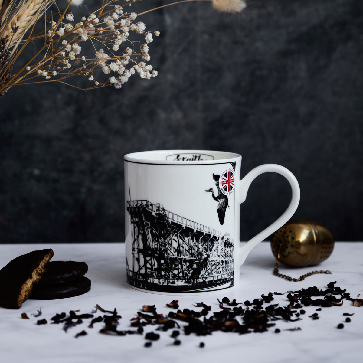 opposite side of the dunston staiths mug featuring a "made in engalnd" sticker, wildlife and the hand drawn design of the staiths.