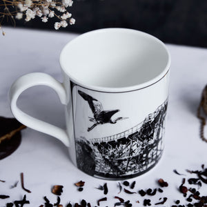 closeup of the mug with various decorations scattered around. the image features some of the hand drawn icons on the mug such as a heron and the staiths