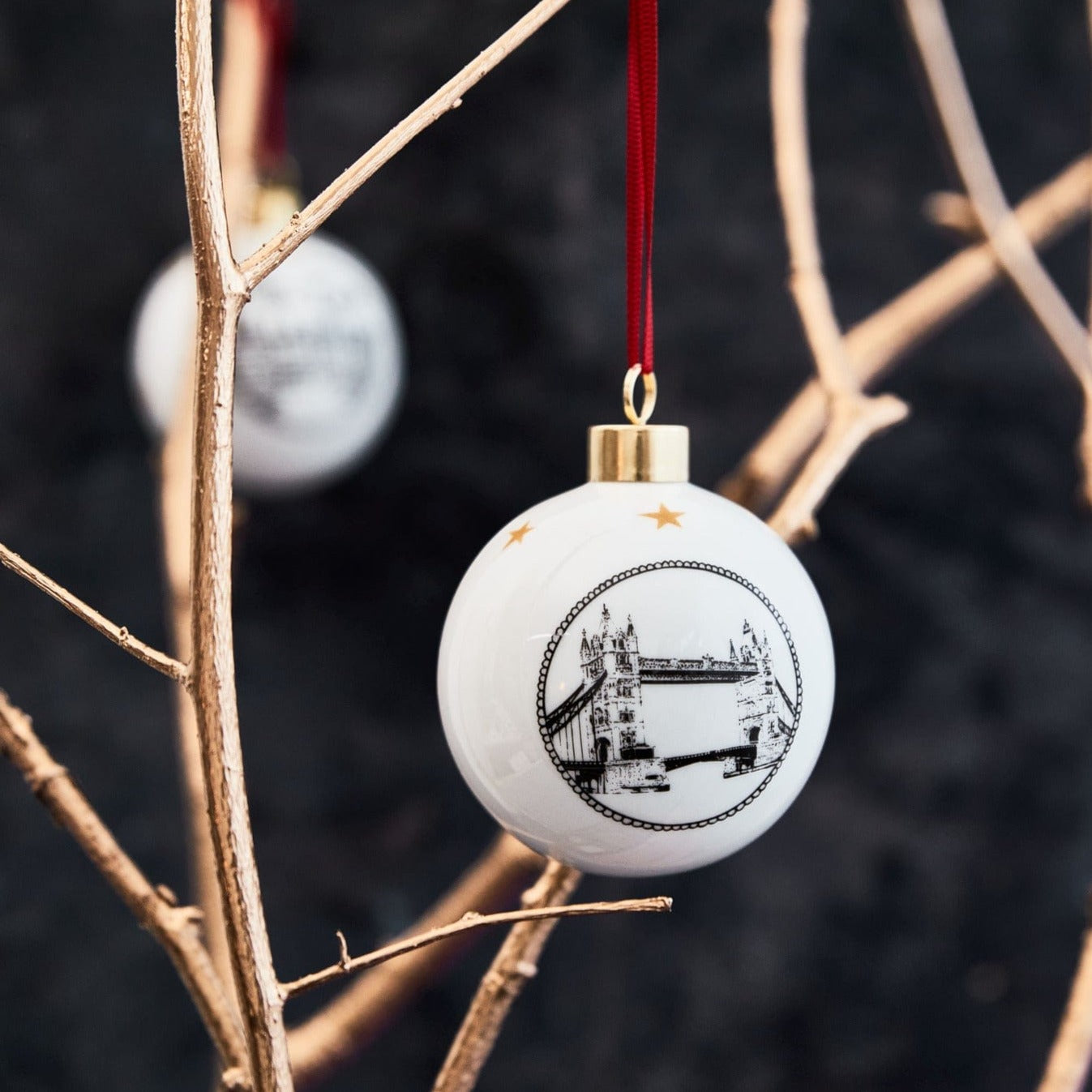 white ceramic holiday ornament by powder butterfly featuring Tower Bridge in a black and white illustration