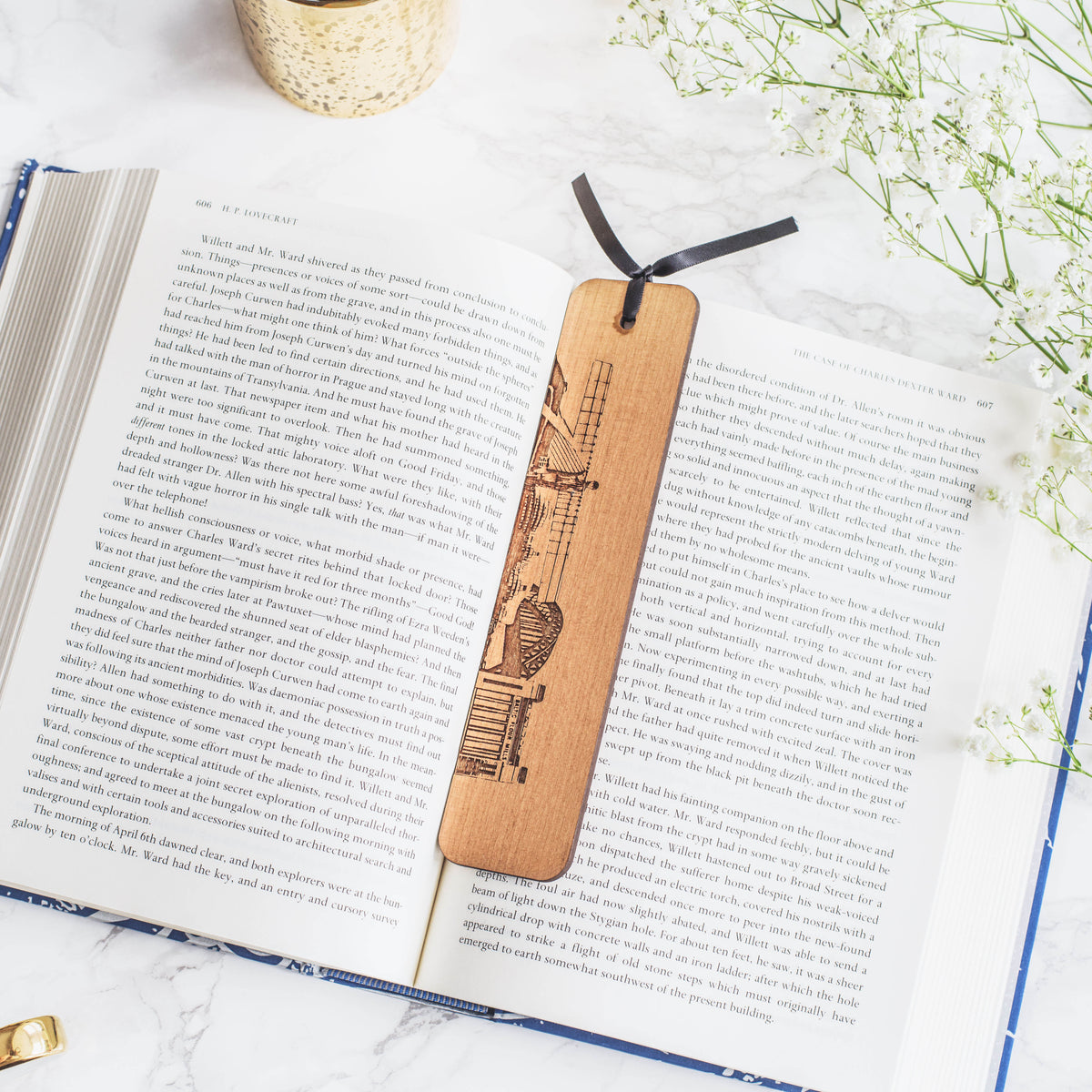 Hand drawn woodburn design of famous newcastle Landmarks by Powder Butterfly. Bookmark is pictured over an open book.