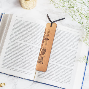 Hand drawn woodburn design of famous newcastle Landmarks by Powder Butterfly. Bookmark is pictured over an open book.