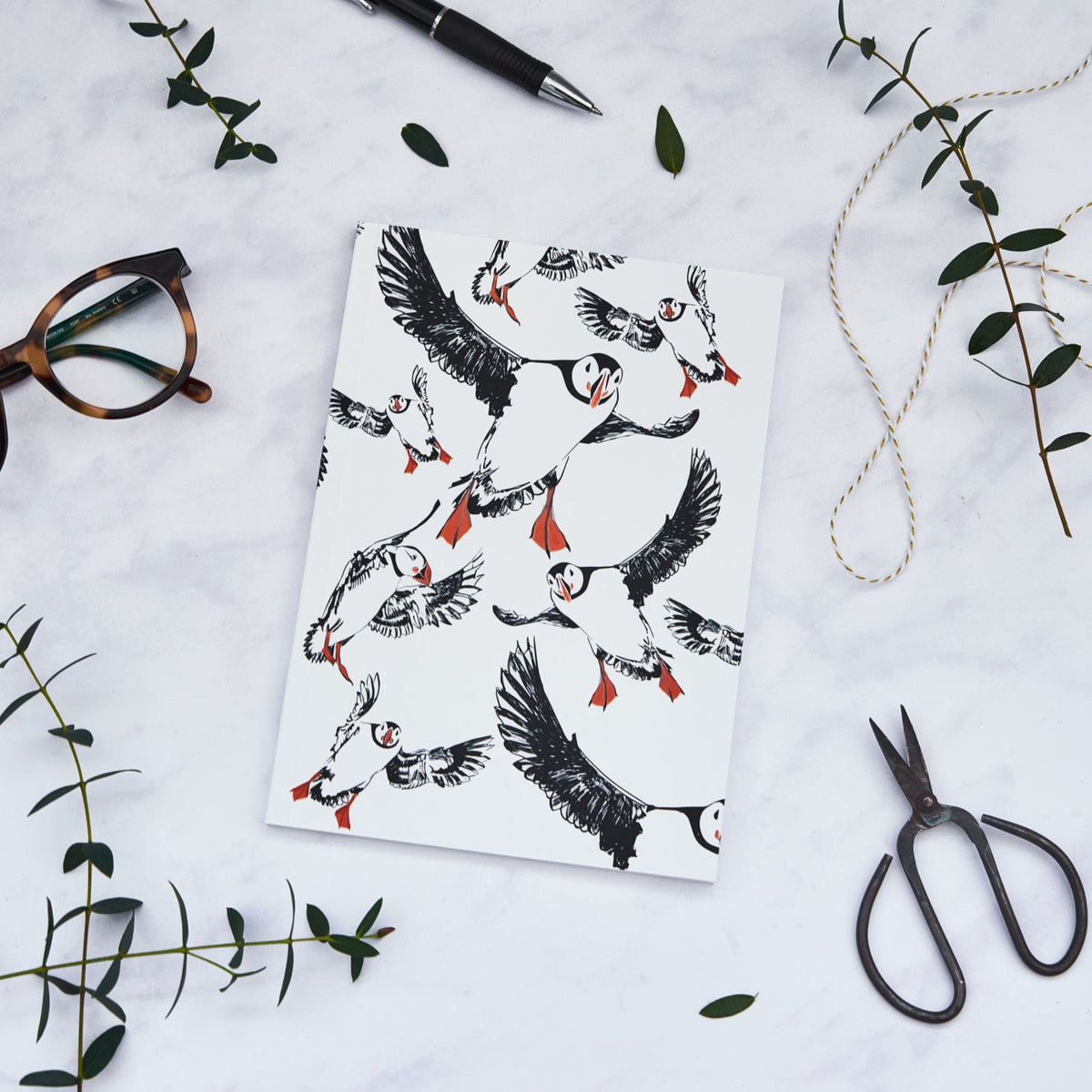 PowderButterfly Stationery Puffin Softback Colour Notebook complete with black and white illustration of puffins, orange details on feet and beaks