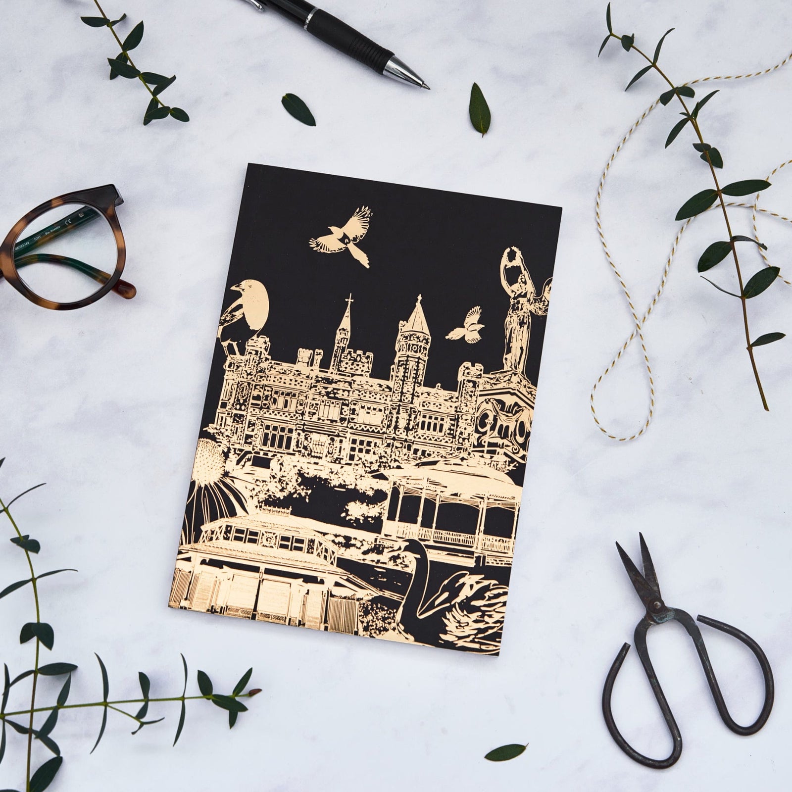 PowderButterfly Stationery Saltwell Park Softback Gold Foil Notebook featuring a gold foil illustration of Saltwell park monuments and landmarks