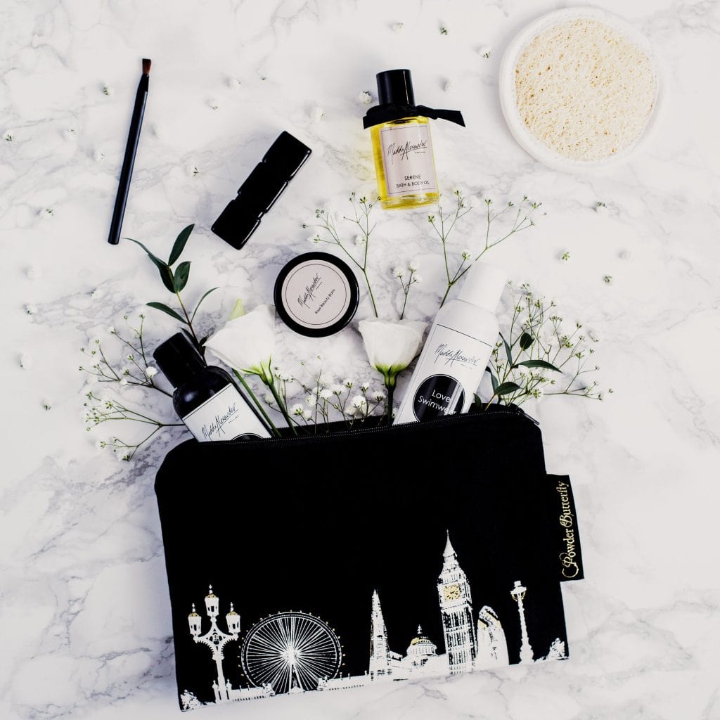 PowderButterfly London Beauty Bag in black featuring a black and white illustration of Lodnons skyline including monuments and landmarks 