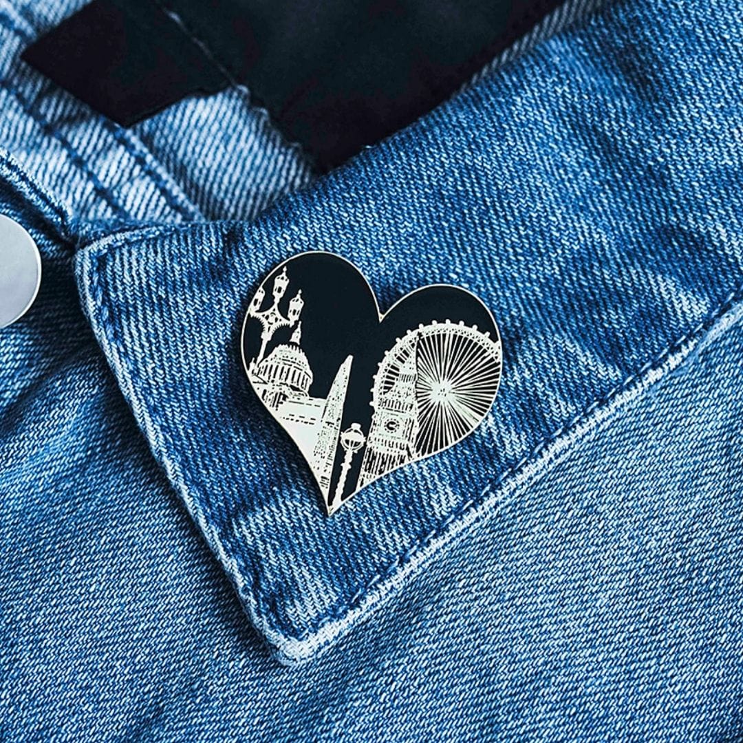 PowderButterfly London Pin Badge with black and silver illustration featuring Londons landmarks and monuments