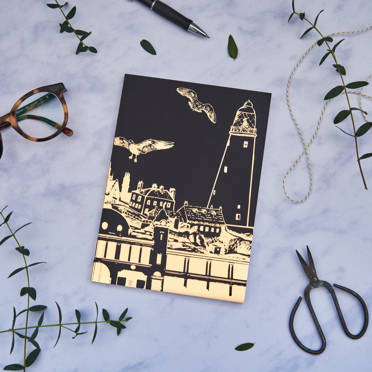 PowderButterfly Whitley Bay Softback Gold Foil Notebook featuring a golf foil illustration of whitley bays various landmarks and monuments